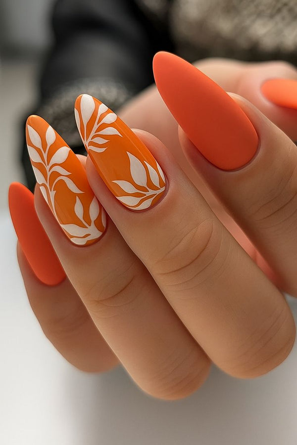 Bright Orange Nails with White Leaf Art Design